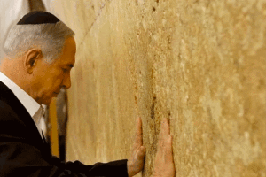 PRAYING FOR STRENGTH: (Benjamin Netanyahu's Facebook Page) 'Evening before the trip to the US, I was praying at the Western Wall. In front of the Western Wall I said that I respect President Barack Obama and I believe in the strength of the relationship between Israel and the US, the strength to overcome our differences. . .' 