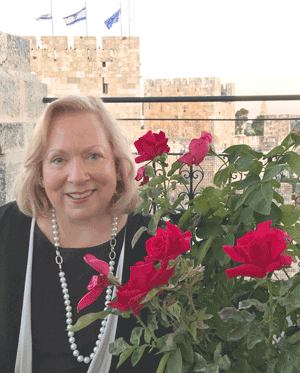 Christine Darg reporting from a strategic vantage point inside Jaffa Gate